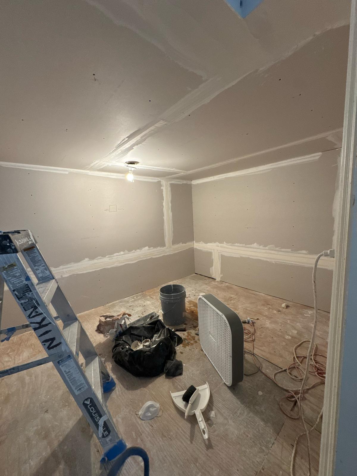Drywall work in progress with tools before painting