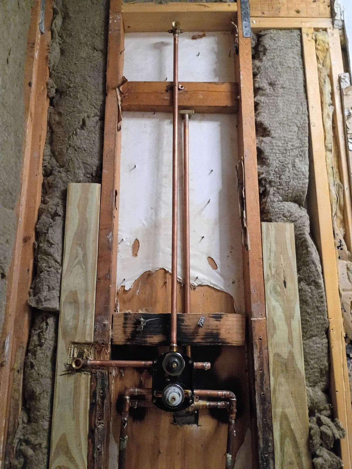 Bathroom plumbing and framing exposed