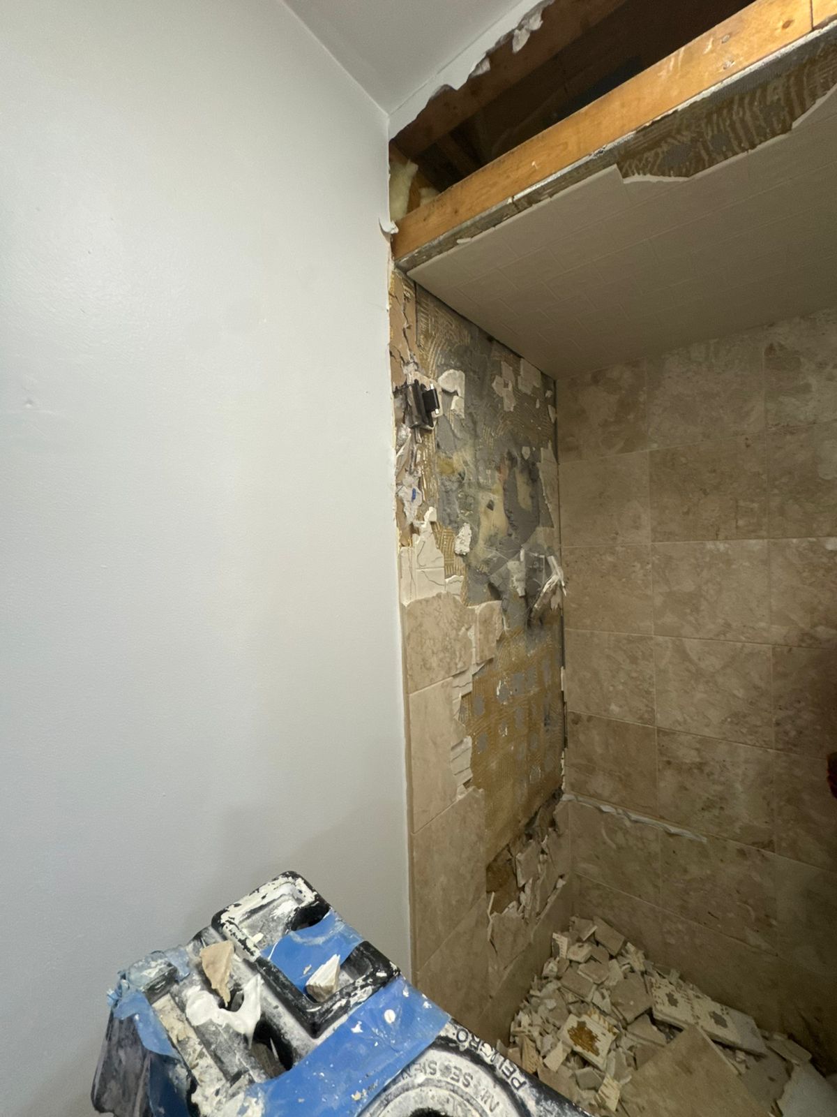 Bathroom tile removal and wall preparation in progress