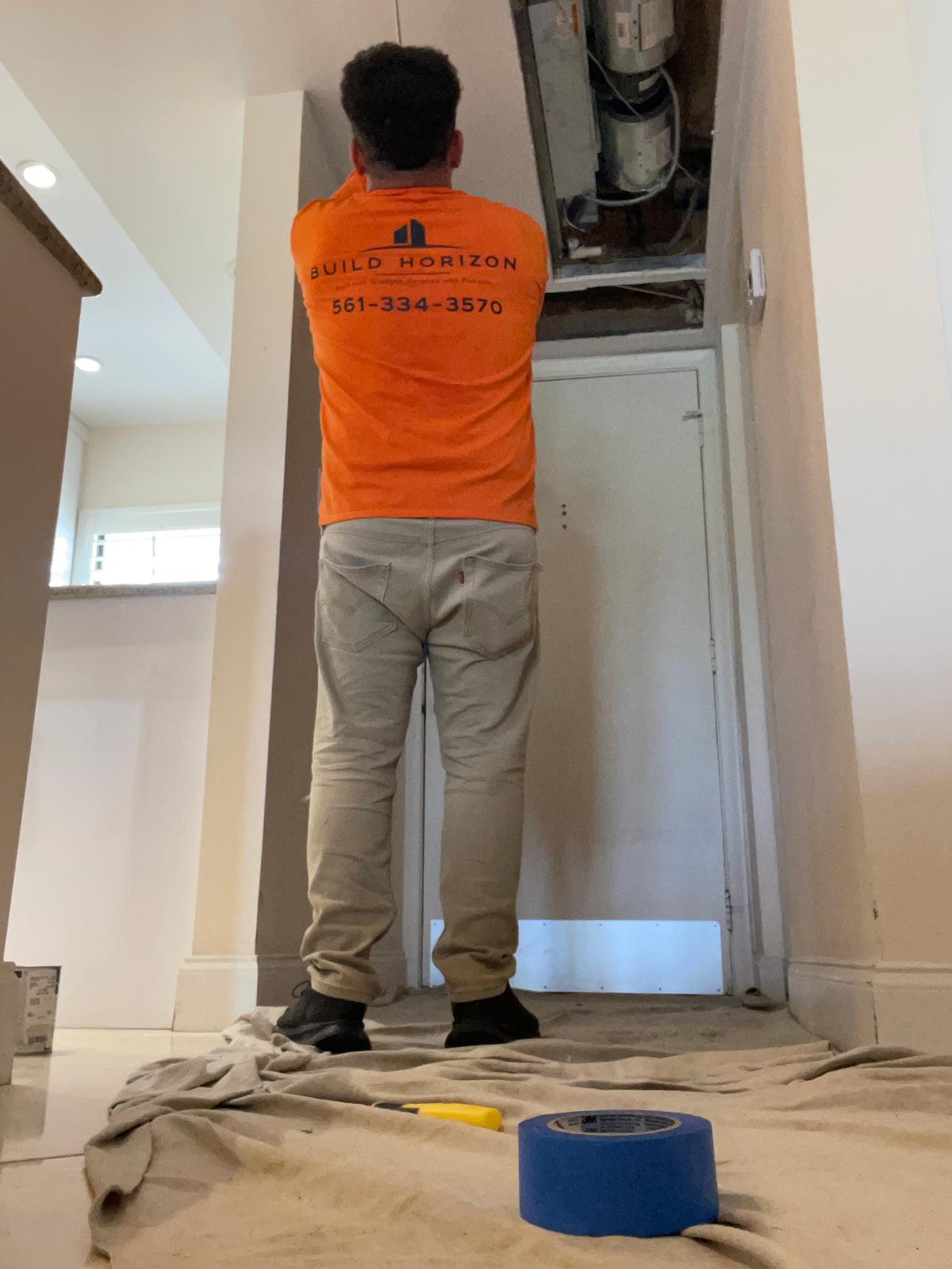 Build Horizon technician working on an air conditioning system