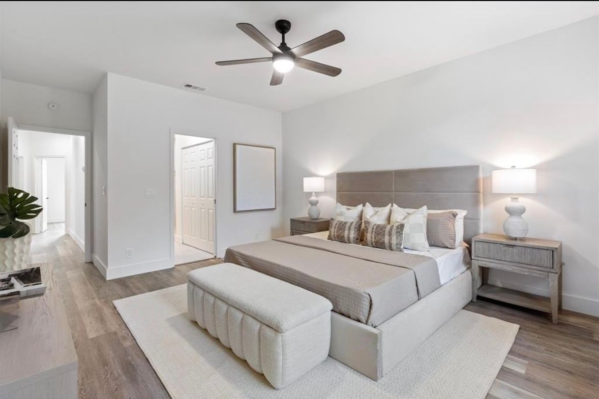 Finished bedroom with neutral materials and ceiling fan