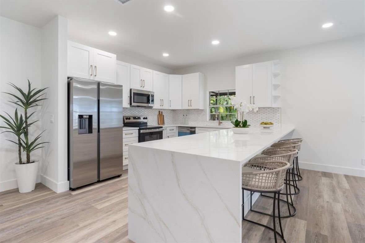 Bright renovated kitchen with island and custom cabinetry